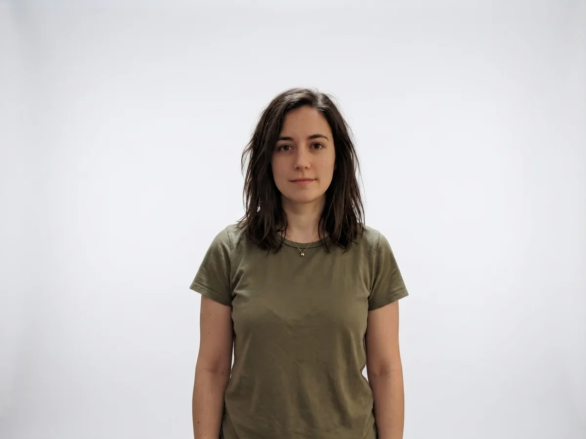 The same woman with her background replaced by a seamless white studio backdrop