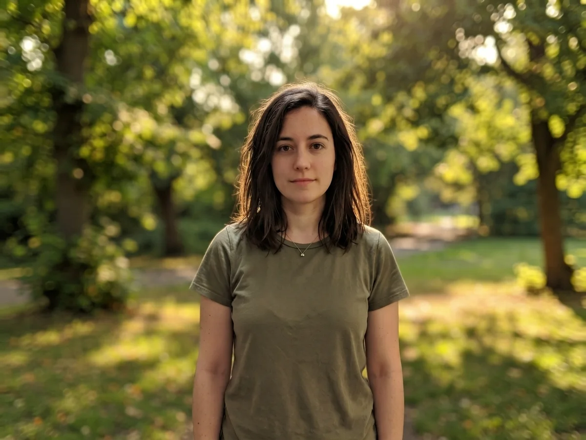 The same woman with her background replaced by a sunlit park with soft-focus trees