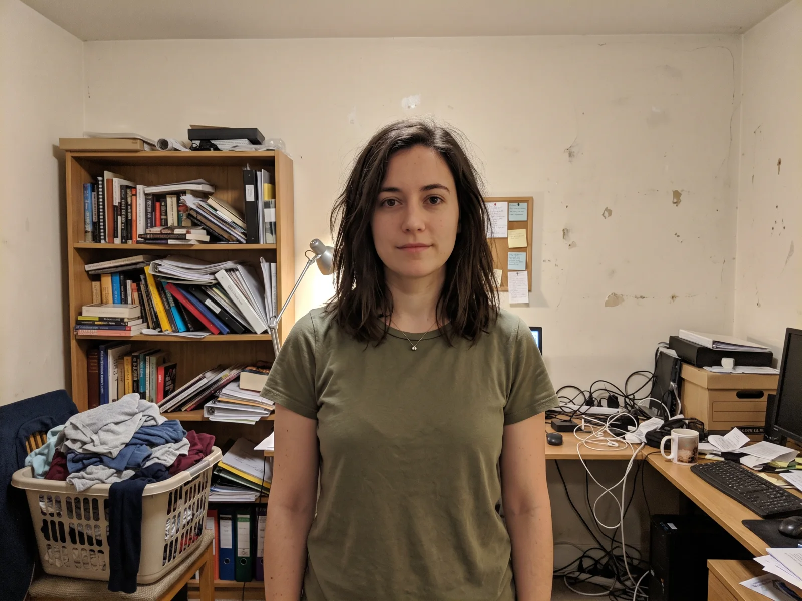 Before: our own AI-generated snapshot of a woman standing in a cluttered home office, used as the background-change input