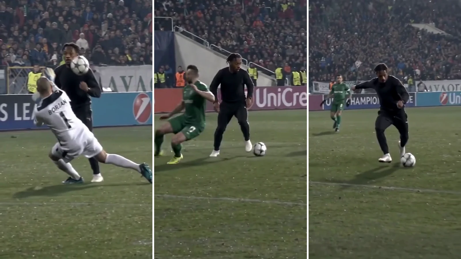 A man in a black sweater and white trainers dribbling past a sliding defender in green under stadium floodlights — a frame from real model output